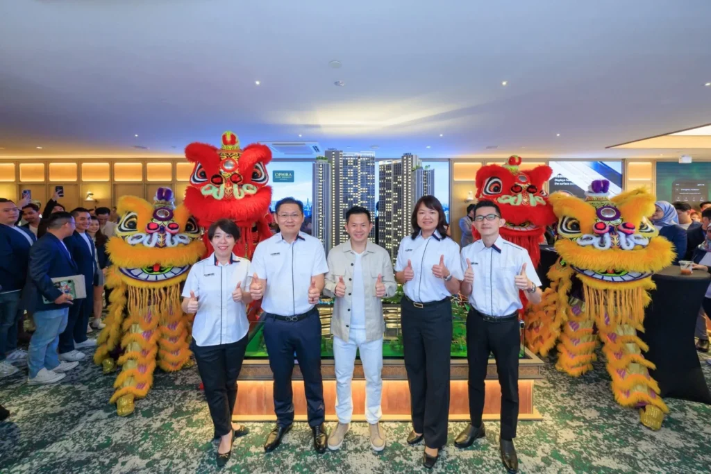 Chin Hin Property representatives and guests at Ophira Resort Residences sales gallery opening with lion dance performers
